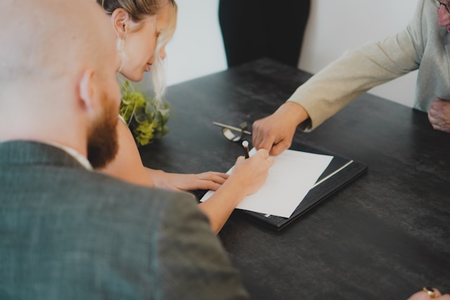 couple signant un contrat auprès d'un conseiller Oney